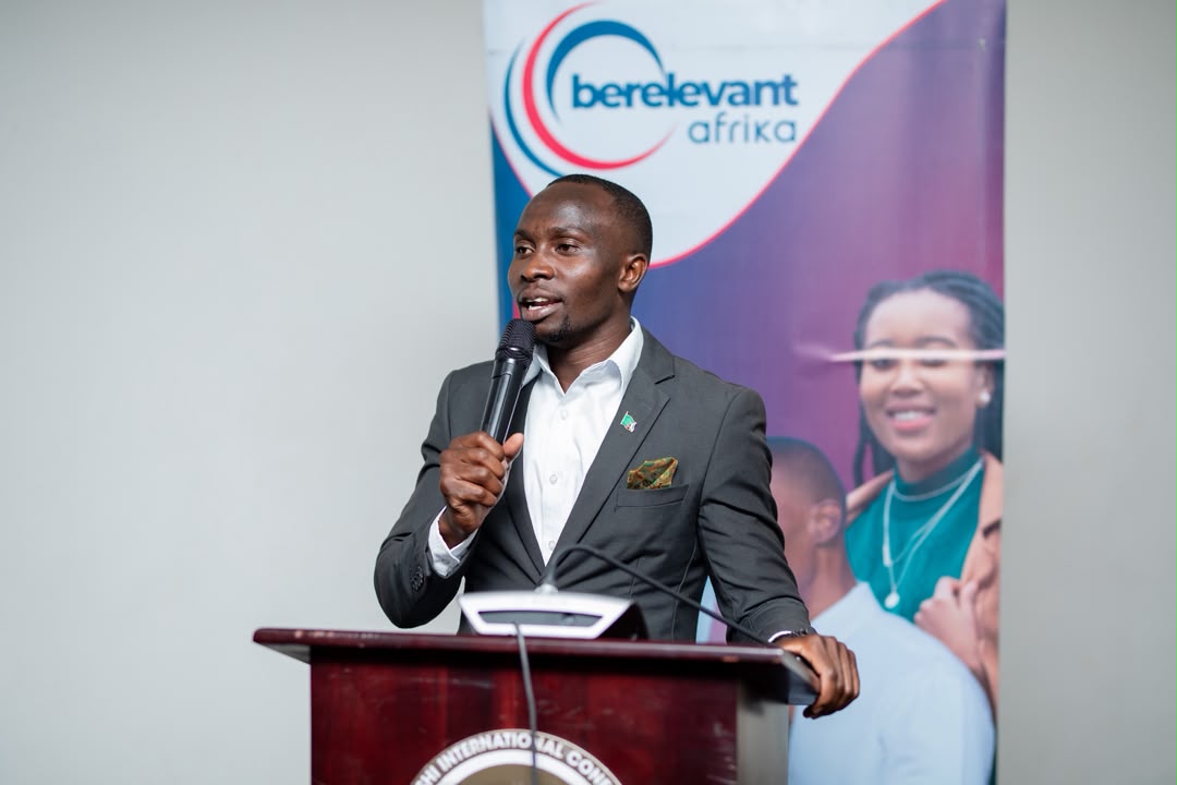A young Zambian speaker at a lectern at a BeRelevant Afrika event