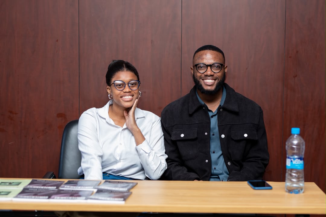 Two smiling young Zambians seated at a BeRelevant Afrika event
